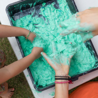 a child and an adult playing with homemade slime and having fun with messy play